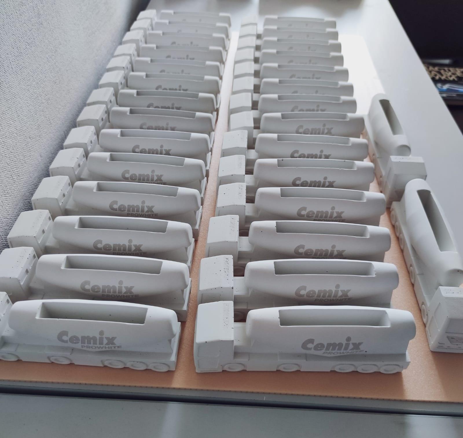 Production run of white concrete Cemix trucks with laser engraved logos, lined up in rows at the JOS Factory workshop