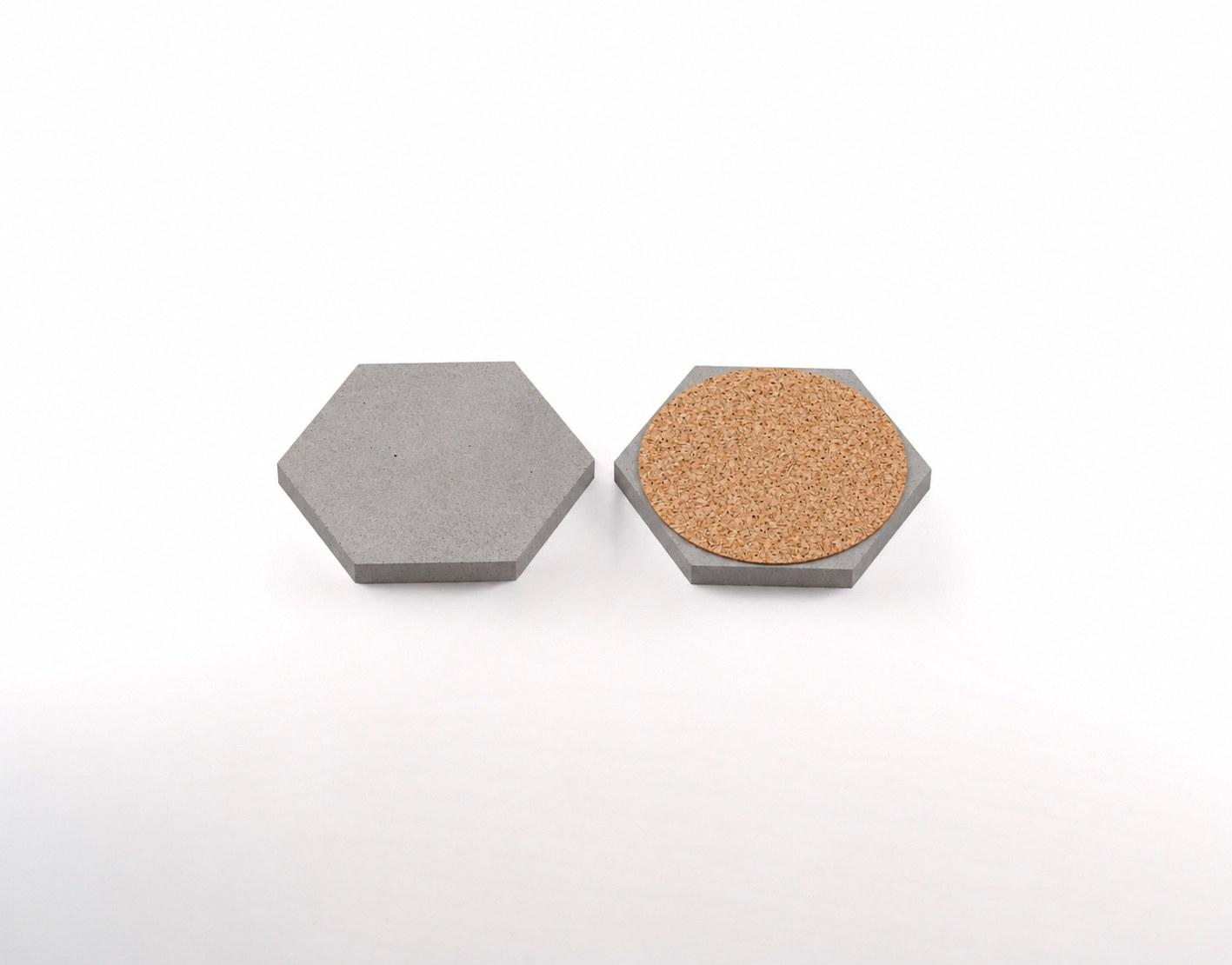 Hexagonal concrete coaster shown from the top and with its cork base