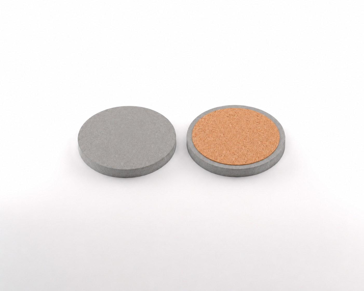 Round concrete coaster shown from the top and with its cork base