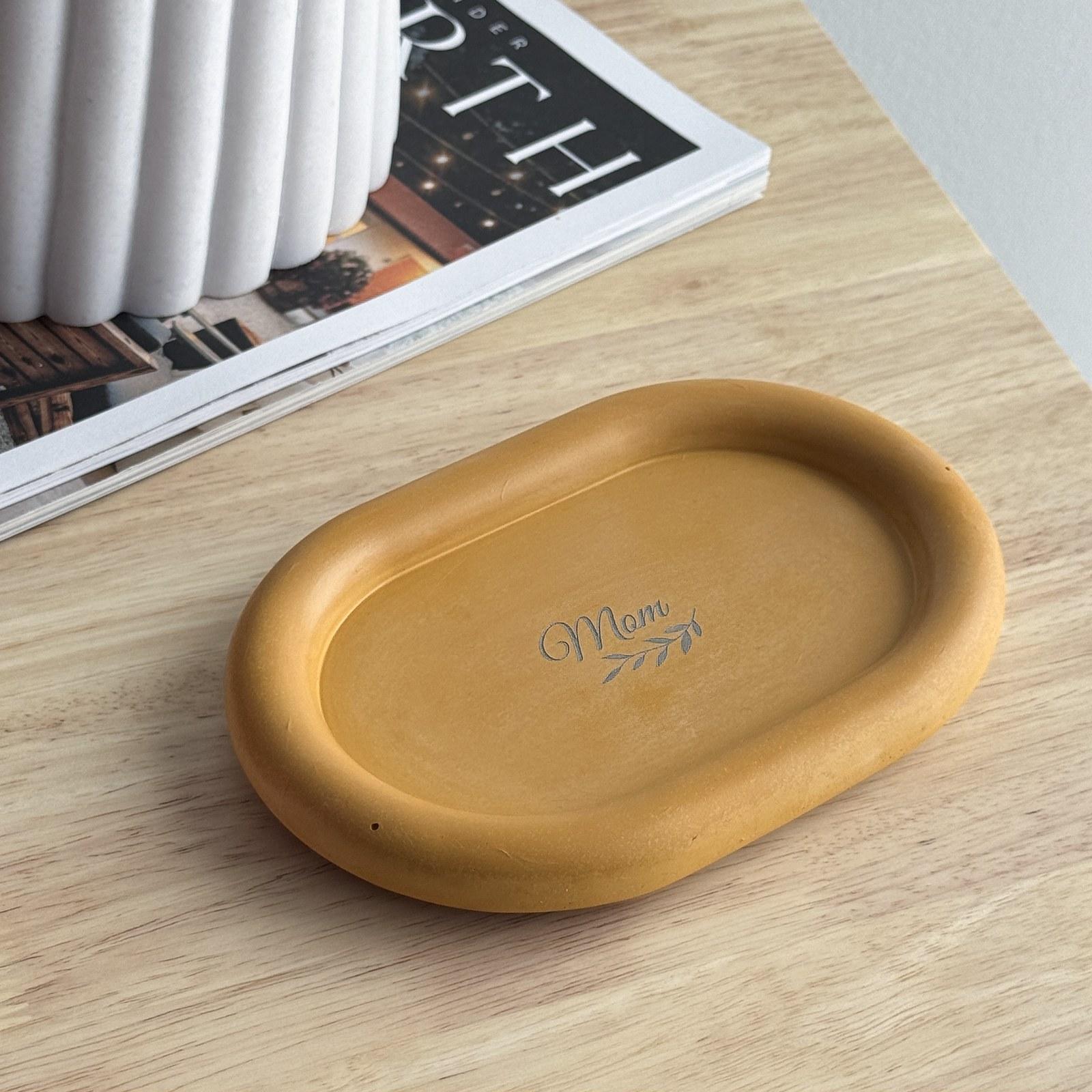 Mustard oval concrete tray engraved with the word Mom